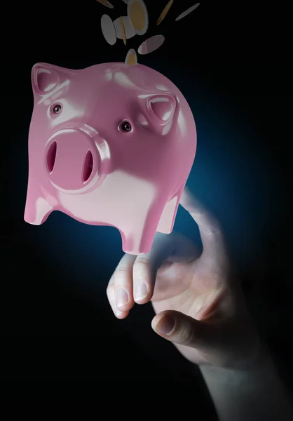 Empresário segurando porquinho banco com moedas voando para dentro 3D — Fotografia de Stock