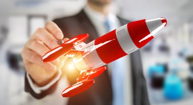 Kırmızı roket onun el 3d render tutan işadamı