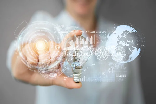 Businesswoman holding a lighbulb with connections in her hand — Stock Photo, Image