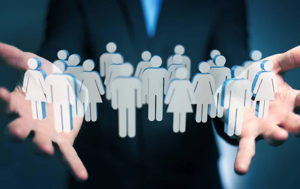 Affärsman som håller 3d rendering grupp människor i handen — Stockfoto