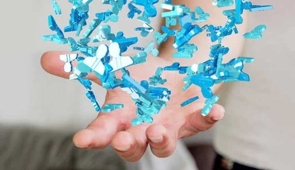 Homme d'affaires tenant un groupe de rendu 3D de personnes bleues — Photo