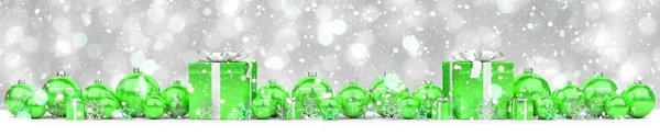 Green and white christmas gifts and baubles lined up 3D renderin