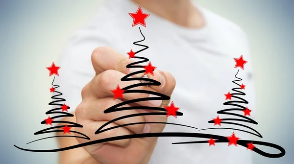 Empresario dibujando árboles de navidad boceto — Foto de Stock