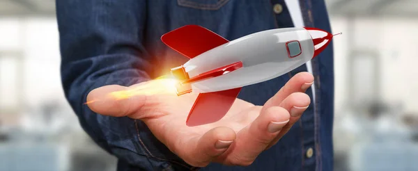 Empresario sosteniendo y tocando un cohete 3D renderizado —  Fotos de Stock