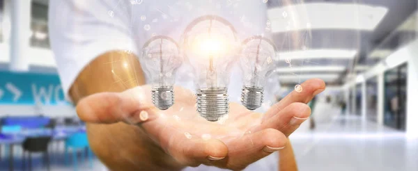 Бизнесмен, соединяющий современные лампочки с соединениями 3D ren — стоковое фото