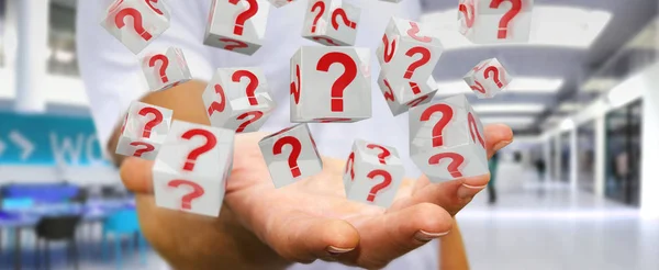 Businessman using cubes with 3D rendering question marks — Stock Photo, Image