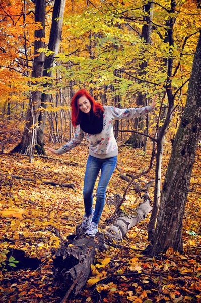 Red-haired girl walking in the autumn forest — Stock Photo, Image