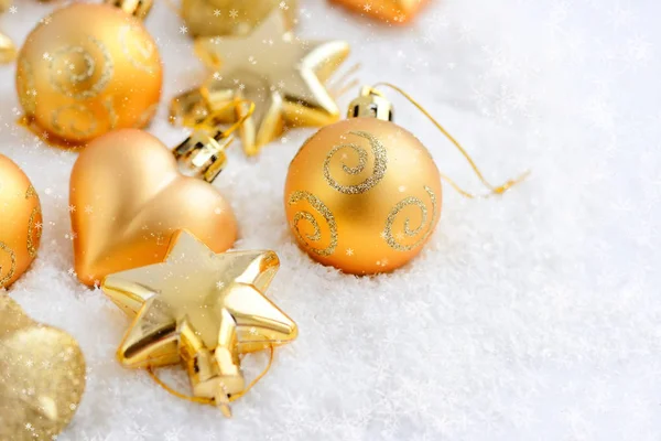 Christmas guld ornament på snön. Festlig jul bakgrund — Stockfoto