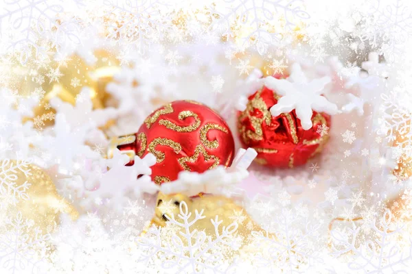 Χριστούγεννα χρυσά και κόκκινα στολίδια πάνω στο χιόνι. Εορταστικό χριστουγεννιάτικο φόντο — Φωτογραφία Αρχείου
