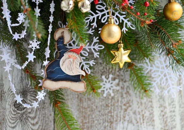 Santa Claus with Christmas decorations on the branches of spruce — Stock Photo, Image