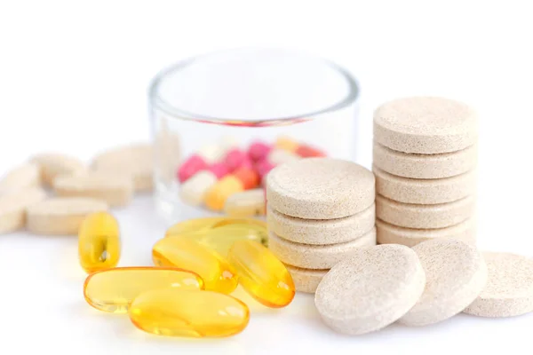 Colored pills, capsules and vitamins on a white background — Stock Photo, Image