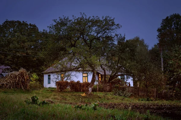 Old hut in village autumn evening scene — Stock Photo, Image