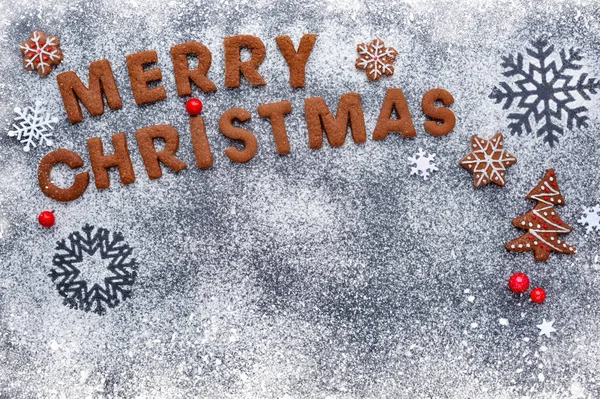 Merry Christmas cookies on a snowy flour with a dark background, — Stock Photo, Image
