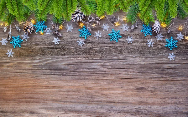 Christmas decorations and spruce branches on a wooden table — Stock Photo, Image