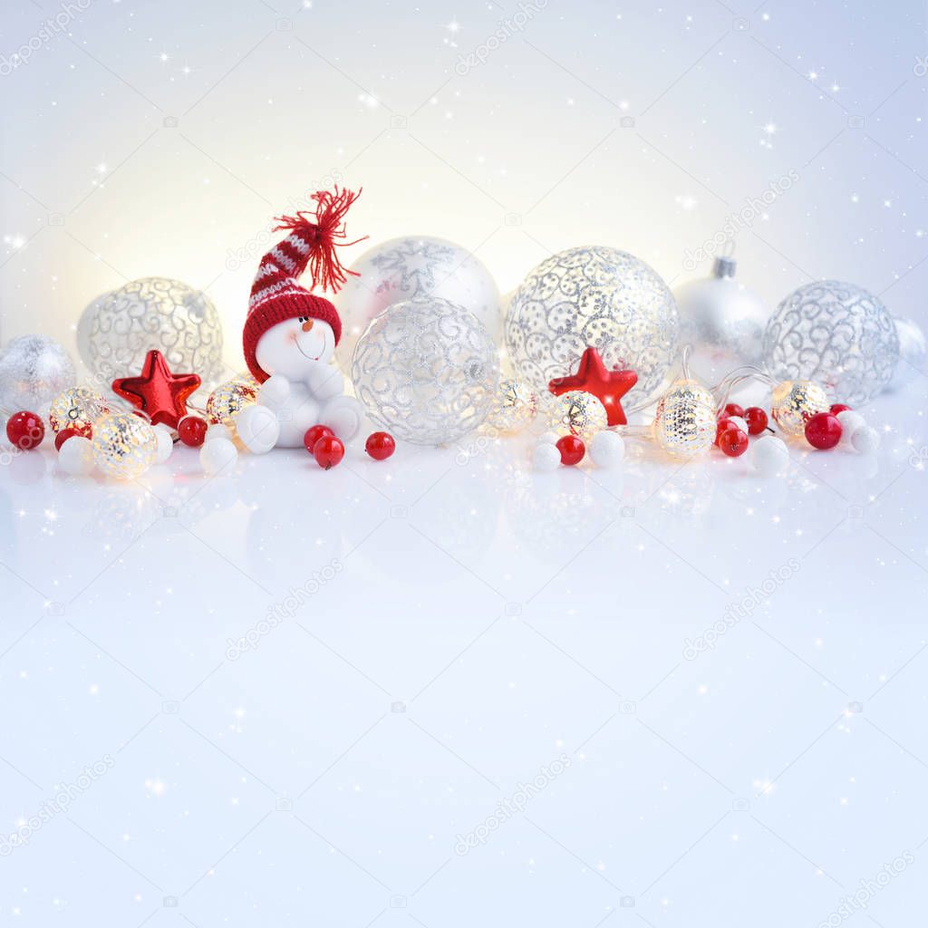 Christmas or New Year background with festive decorations. Snowman, christmas balls and lights. Space for your text.
