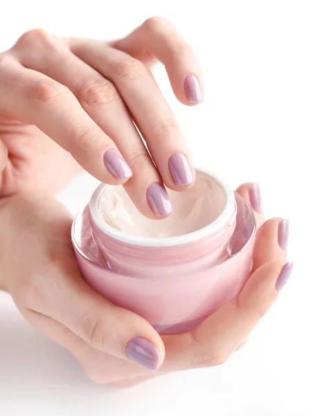 Hands of a woman with pink manicure with cream — Stock Photo, Image