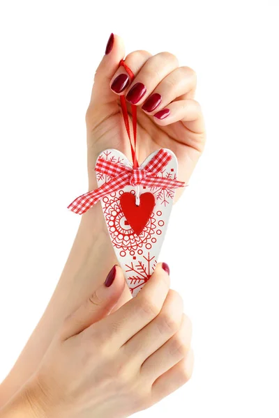 Heart handmade in hand of girl with red manicure on white background — Stock Photo, Image