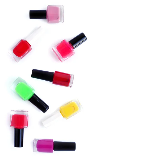 Coloured nail polish bottles on white background with copy space — Stock Photo, Image