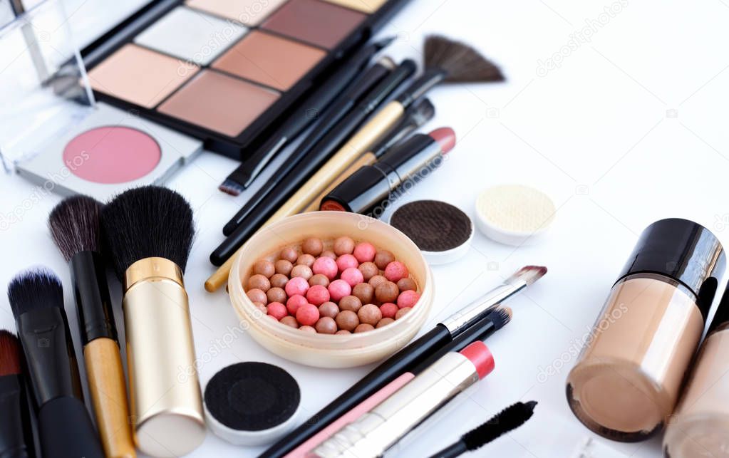 Makeup brush and decorative cosmetics on a white background 