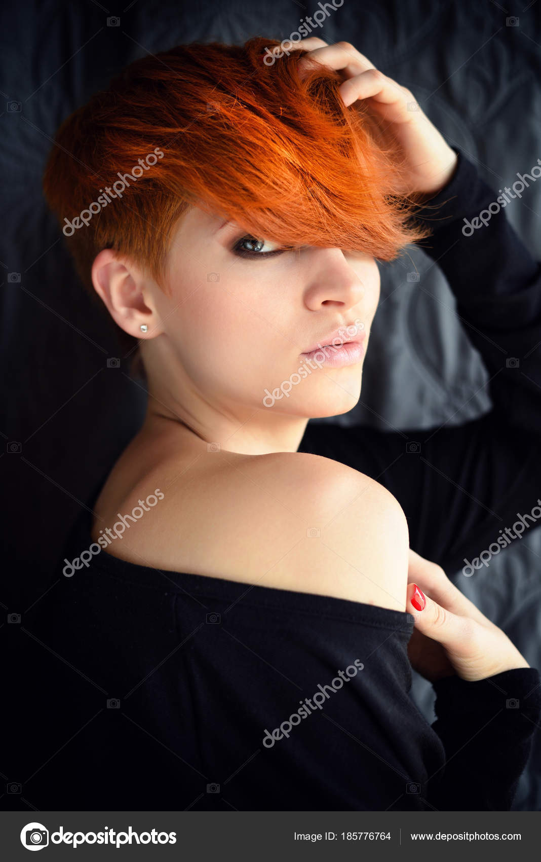 Portrait of a beautiful young red-haired woman with short hair on a
