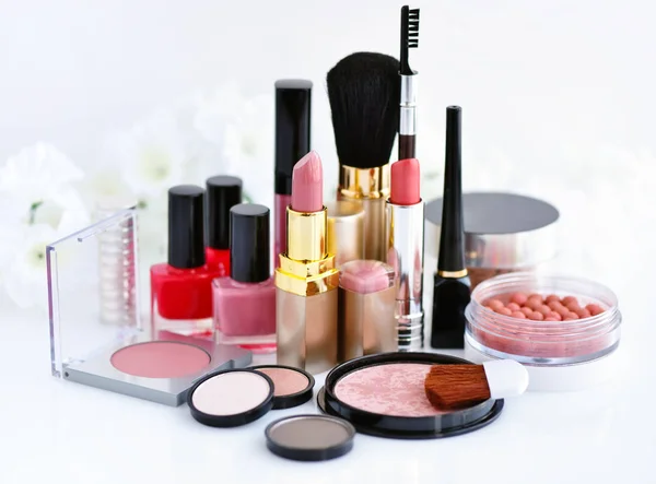 Set of decorative cosmetic: powder, lipsticks, brush, blush, eyeshadow, nail polish on a white background — Stock Photo, Image