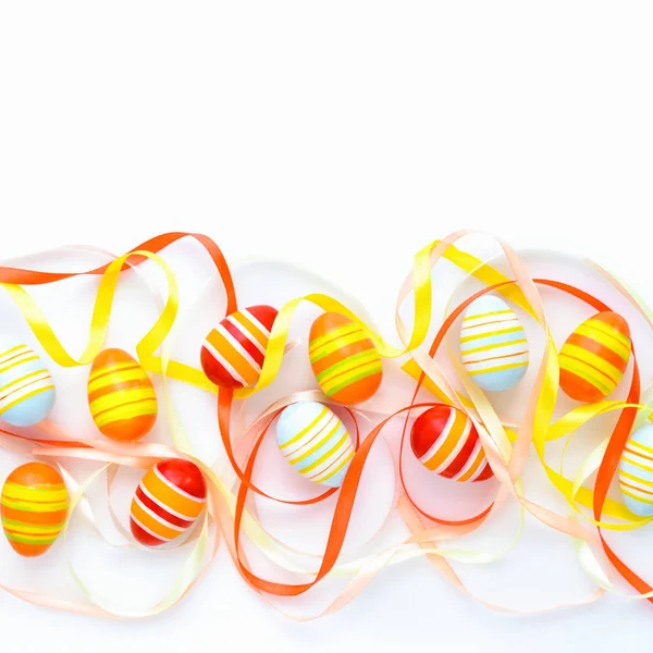 Colorful easter eggs and multicolored ribbons with empty space. — Stock Photo, Image
