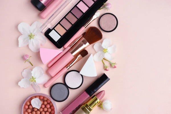 Кисть для макияжа и декоративная косметика с цветом яблока на розовом фоне — стоковое фото