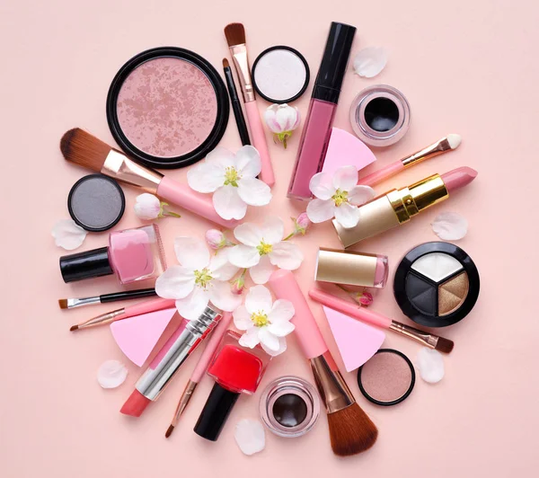 Decorative cosmetics with apple blossom on a pastel pink background — Stock Photo, Image