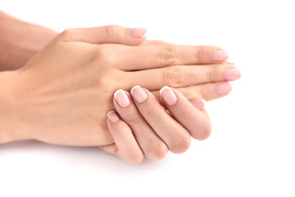 Mooie vrouw handen met franse manicure op een witte achtergrond — Stockfoto