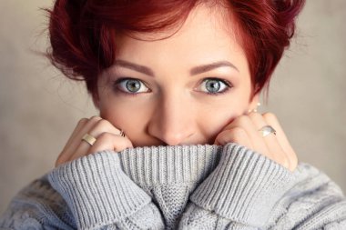 Sıcak yün kazak giyen kısa saçlı güzel bir genç Kızıl saçlı kadın portresi