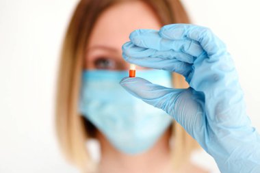 Genç ve çekici bir kadın hastasına götürmesi için bir hap tutuyor. Sağlık ve Tıp Konsepti.