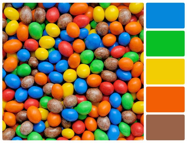 Pile of colorful chocolate coated candy with palette color swatc
