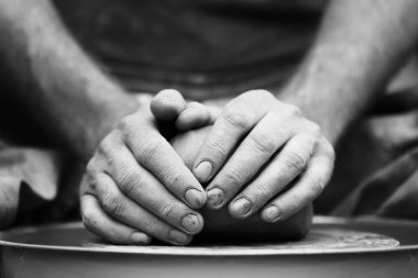 Potter çömlek çarkında seramik demlik yapıyor.