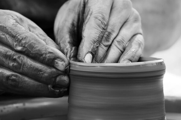 Potter making ceramic pot on the pottery wheel