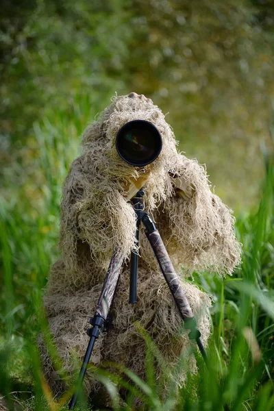 Camouflage wildlife photographer in the ghillie suit — Stock Photo, Image