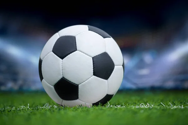 Closeup soccer ball in green grass on stadium — Stock Photo, Image