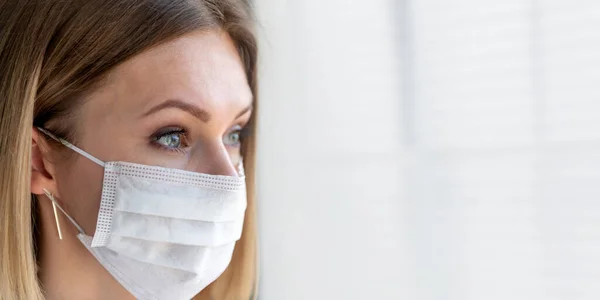 Nurse or doctor with face mask. Health care, surgery. Close up portrait of young caucasian woman model on white background