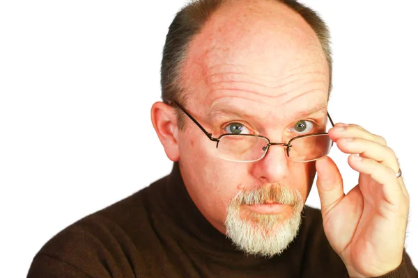 Handsome bald man with goatee looking over glasses Royalty Free Stock Images