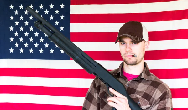 Young Man Holding Gun on American Flag Background — Stock Photo, Image