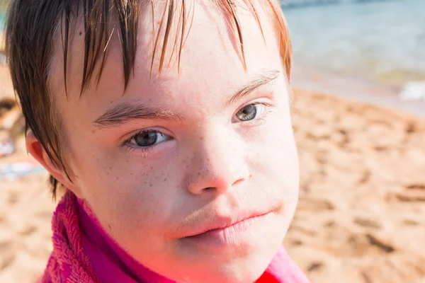 Pojke med Downs syndrom på stranden — Stockfoto