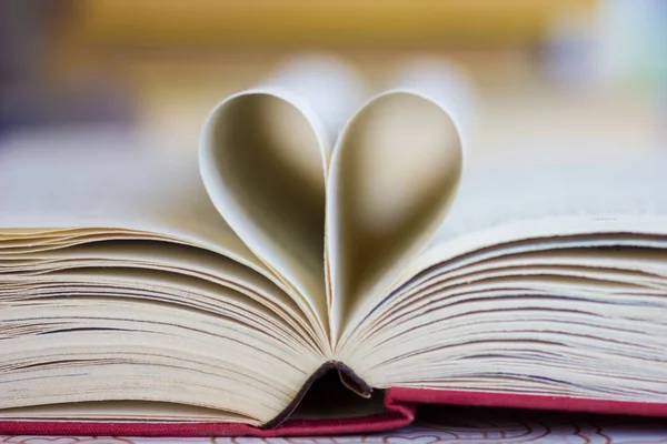 Opened book with heart shaped pages Stock Image