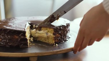 Kız çikolatalı pasta bir parça kesip bir plaka yakın çekim vuruşta yerleştirir