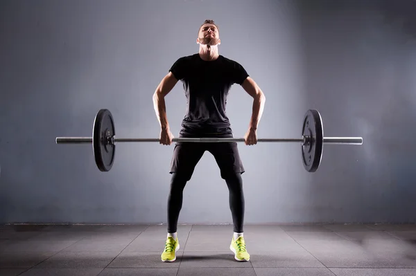 Jeden muž handsom zdvihací sumec. CrossFit fitness tělocvičně těžká váha bar u silné cvičení — Stock fotografie