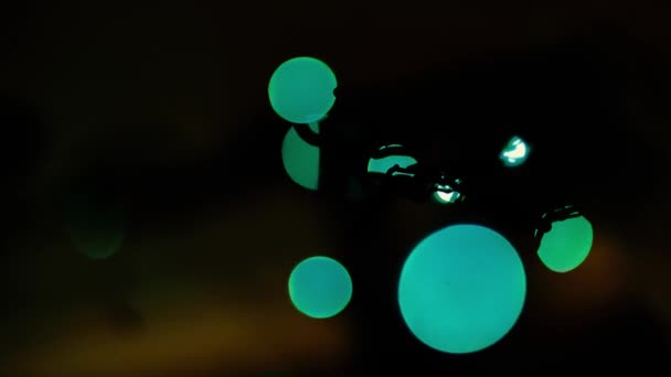 Colorful octagons blink on dark background. Multicolored defocused lights blinking. — Stock Video