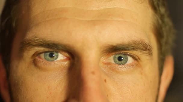 The eyes of a young white male close-up shot. they winks and laughs, visible wrinkles — Stock Video