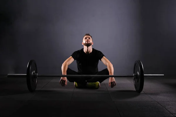 Athlete motivates before barbells exercise at gym