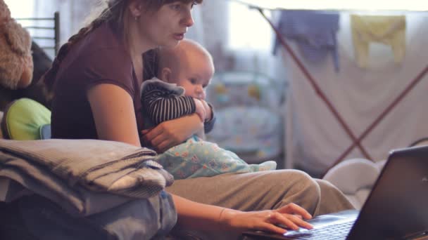 Mother with her baby using laptop — Stock Video