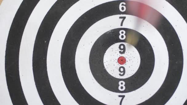 Close up of darts hitting the bulls eye on a dartboard Concept of successful business ideas hitting the exact center of the target. Perfect performance of the task and superiority over the rivals — Stock Video