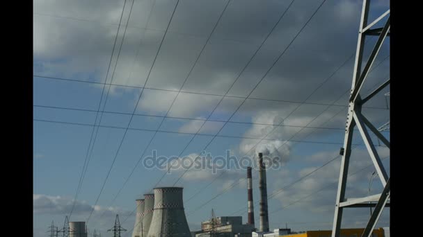 Smoke steam comes from the chimney. Smoke from a pipe against a blue sky covered with wires. Cogeneration power plant in the city. The chimneys smoke pipe is smoke. Single-frame shooting, interval — Stock Video