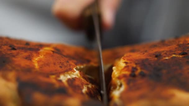 Chef mão tomando um delicioso pedaço de pizza com queijo picles de salame em uma placa de madeira. Comida tradicional italiana — Vídeo de Stock